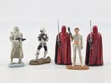 star wars action figures are lined up on a white surface