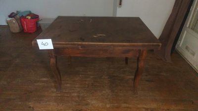 a wooden table with a sign on it in a room