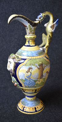a blue and yellow vase with a bird on top of it