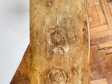 a wooden cutting board sitting on the floor next to a wall
