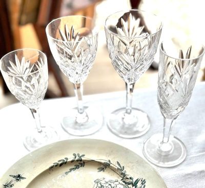 quatre verres à vin et une assiette posés sur une table