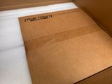 a cardboard box with a white towel inside of it