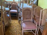 a lot of chairs and tables in this room