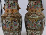 pair of chinese vases on display in a glass case