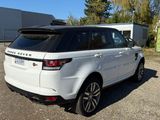 a picture of a white land rover parked in front of a building