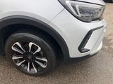 a close up of the front of a white car with black rims