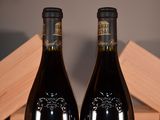 two bottles of wine that are sitting on a table