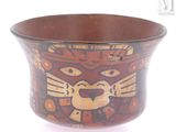a brown bowl with a design on it on a white surface