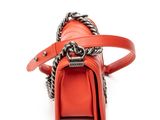 a close up of a red purse with a chain around it