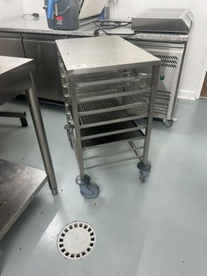 a kitchen with a lot of stainless steel items on the floor