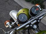 a close up of a motorcycle with a speedometer on the handlebars