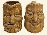 two brown vases with faces on them on a white background