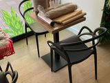 a table and chairs in a room with a window