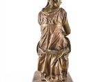 an antique bronze statue of a woman with a dog on a wooden base