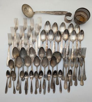 a lot of silver spoons and spoons on the table