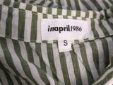 an image of a green and white striped shirt with a label on it