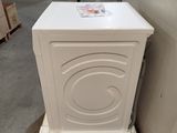 a white washing machine sitting on a pallet in a warehouse