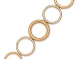 a close up of a bracelet with gold rings on a white background