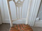 a white chair with a striped seat pad on the floor
