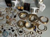 a lot of gold and silver jewelry on the table