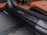 the interior of a car with the door open and the driver ' s seat down