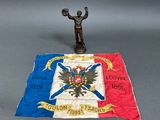 a statue of a man holding a flag on a table