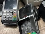 three cell phones sitting on a table next to each other