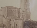 an old photo of a large building with a clock tower