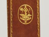an old book with a gold medallion on the cover