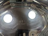 a close up of a silver plate with two holes in it