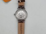 a close up of a watch on a white surface with a price tag
