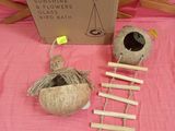 a box with a ladder, a ball of yarn, and a ball of yarn on a pink table cloth