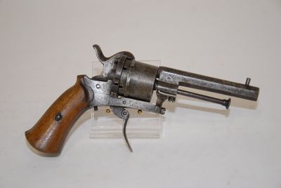 an old revolver with a wooden handle on a white surface