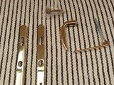 two pieces of metal on a striped table cloth