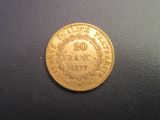 a close up of a gold coin on a black surface