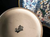 someone is holding a plate with a picture on it and a bowl with a picture on it