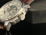 a close up of a watch on a black surface