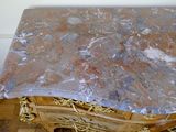 a marble top table with gold detailing on it