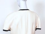 the back view of a mannequin dress with black trims