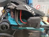 a close up of a blue and black lawn mower