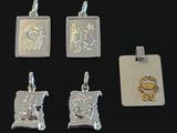 four silver and gold pendants with a picture of a man and a woman