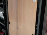 a large wooden door in the middle of a room