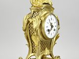 a gold clock that is sitting on a table