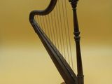 a close up of a black harp on a wooden stand