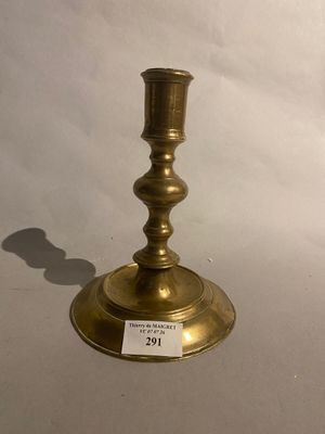 a brass candle holder with a price tag on it