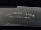 a close up of a knife on a black surface