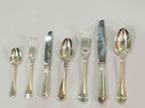 a lot of silver spoons and forks on the table