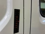 a close up of a train door with a ruler on it