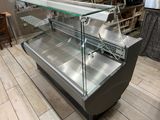 a display case that has a glass top and a metal base