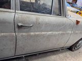 a dirty car parked on the side of the street